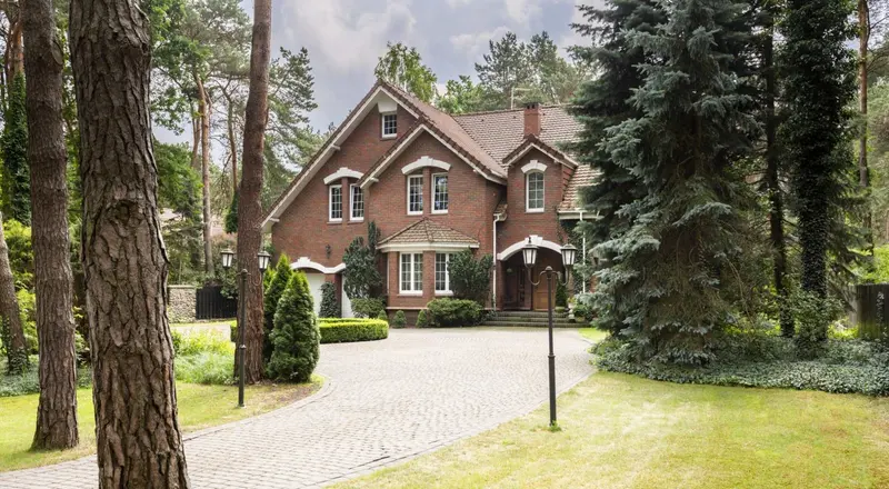 Large rural property with lawn and mature trees maintained by Pollards Forestry & Landscaping Contractors